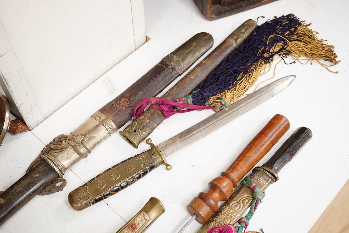 Four Tibetan daggers, early 20th century and a prayer wheel